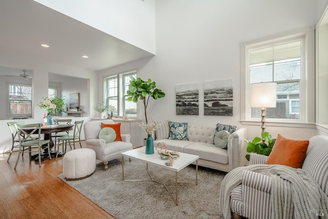 living room featuring light hardwood / wood-style floors and ceiling fan