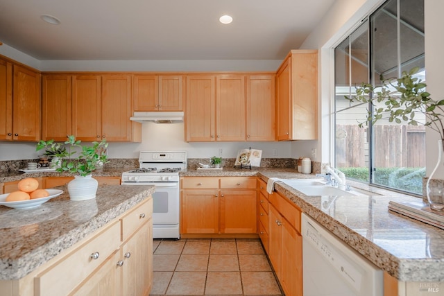 kitchen with white appliances, sink, light stone counters, and light tile flooring