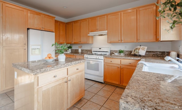 kitchen with a kitchen island, light tile flooring, white appliances, sink, and light stone counters