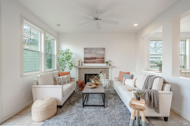 living room featuring light tile flooring and ceiling fan