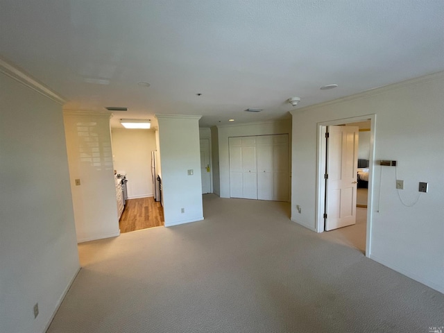 carpeted empty room featuring crown molding