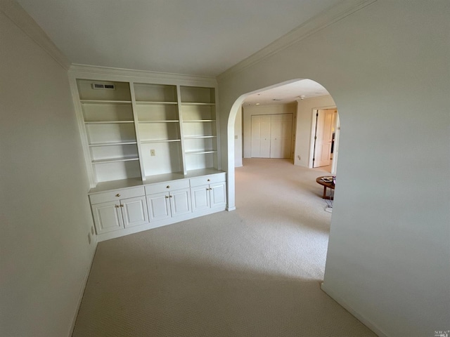 hall featuring ornamental molding and carpet floors