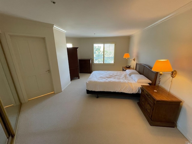 bedroom featuring crown molding and light carpet