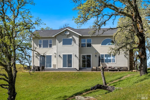 back of property featuring a patio and a lawn