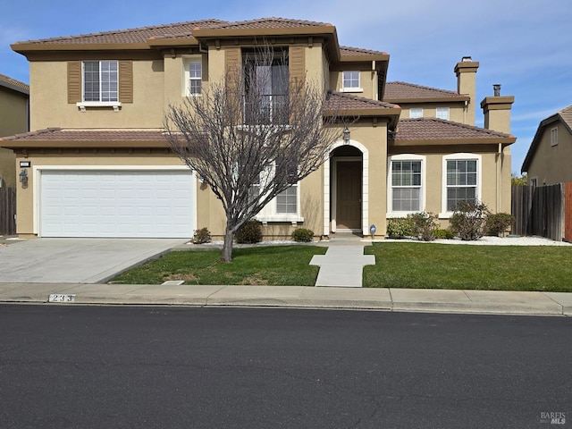 mediterranean / spanish-style house featuring a garage and a front yard