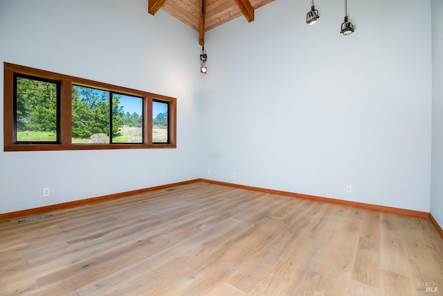 unfurnished room featuring baseboards, wooden ceiling, light wood-style floors, beamed ceiling, and high vaulted ceiling