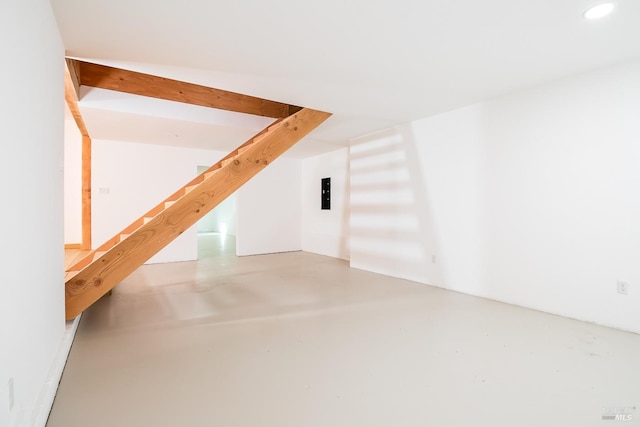 additional living space featuring concrete floors, recessed lighting, and stairs