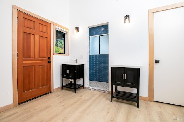 foyer featuring baseboards and light wood-type flooring