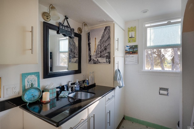 kitchen featuring sink, a wealth of natural light, and white cabinets