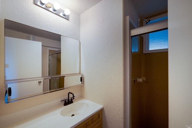 bathroom featuring vanity and a textured ceiling