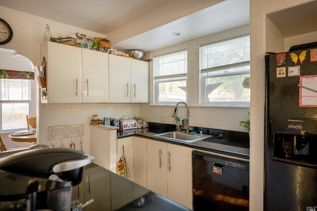 kitchen featuring sink, white cabinetry, and black appliances