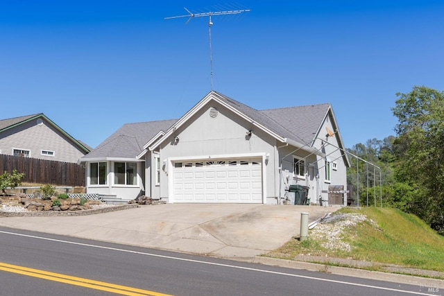 single story home featuring a garage, concrete driveway, fence, and stucco siding