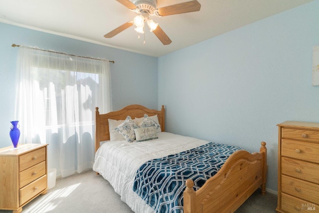 bedroom with ceiling fan and light carpet