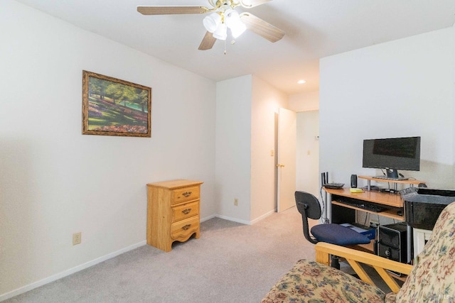 carpeted home office featuring ceiling fan