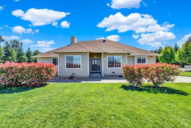 view of front of home with a chimney and a front yard