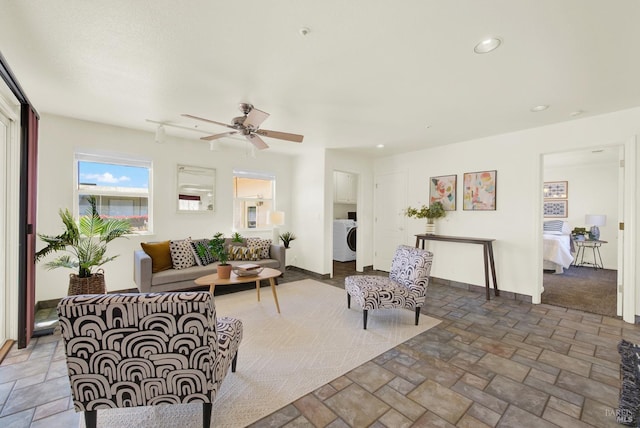 living room with recessed lighting, a ceiling fan, washer / dryer, and stone finish floor