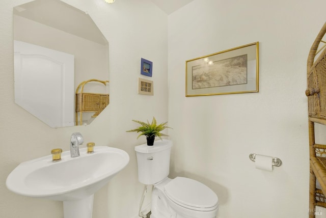 half bath with toilet and a sink