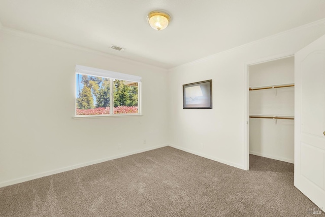 unfurnished bedroom with visible vents, crown molding, baseboards, and carpet floors