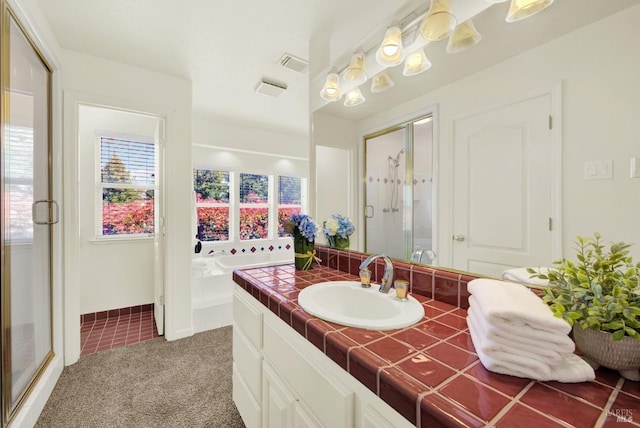 bathroom featuring visible vents, a garden tub, vanity, baseboards, and a stall shower