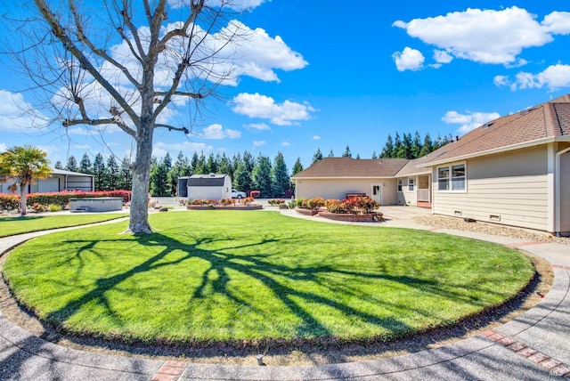 view of yard featuring a storage shed and an outdoor structure