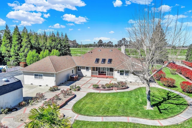 back of property with a lawn, an outbuilding, a chimney, and a patio area