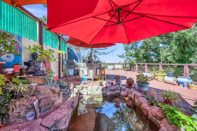 view of patio / terrace featuring outdoor dry bar and a wooden deck