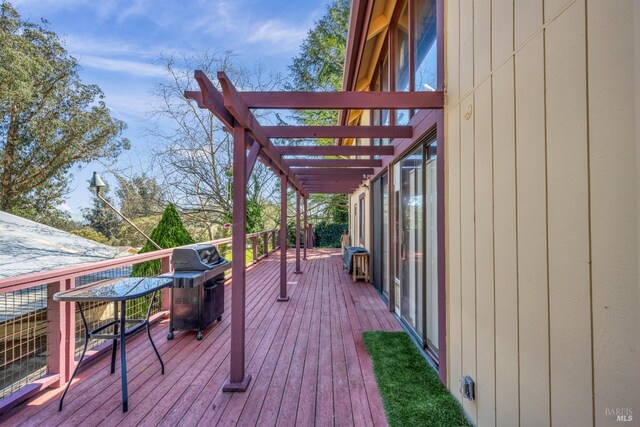 deck featuring a pergola and a grill