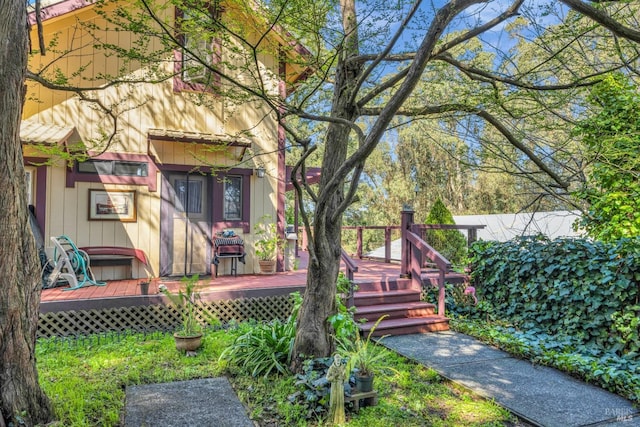 rear view of house with a wooden deck
