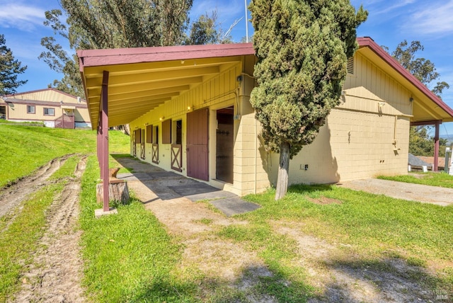 view of front of property with an exterior structure and concrete block siding