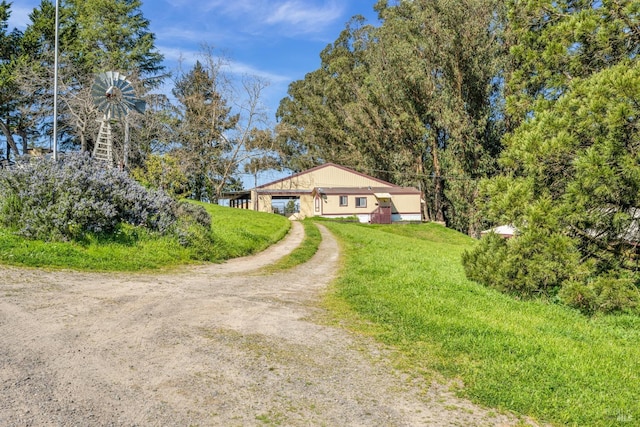 view of front of home with driveway and a front lawn