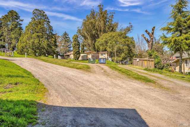 view of street with dirt driveway