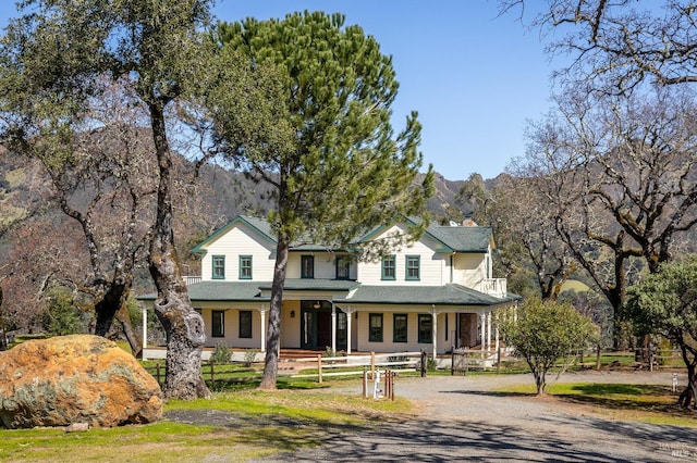 farmhouse inspired home featuring a porch and a mountain view