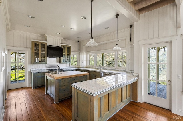 kitchen with beam ceiling, extractor fan, dark wood-type flooring, and a wealth of natural light