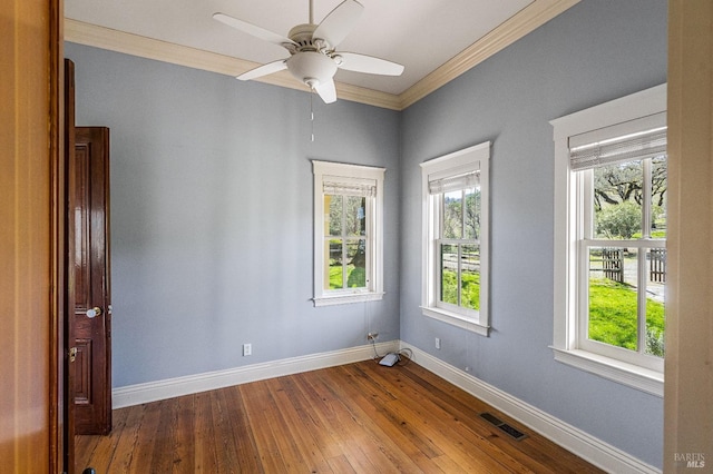 unfurnished room with dark hardwood / wood-style flooring, ceiling fan, and crown molding