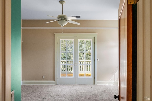 empty room with ceiling fan, light carpet, and french doors