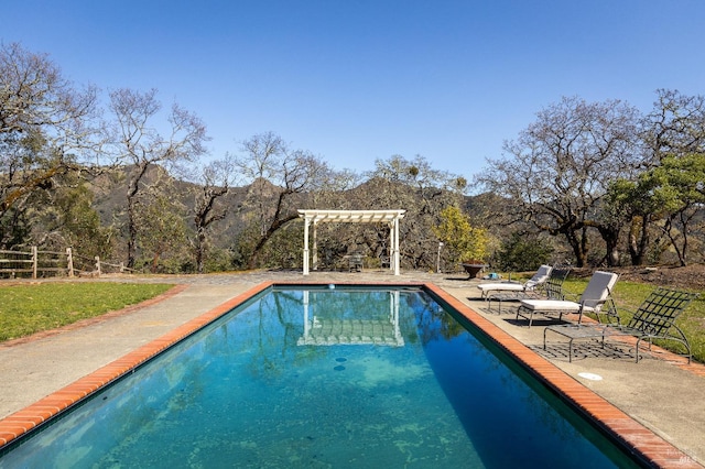 view of pool featuring a pergola, a mountain view, and a patio