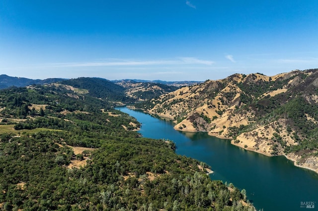 drone / aerial view featuring a water and mountain view