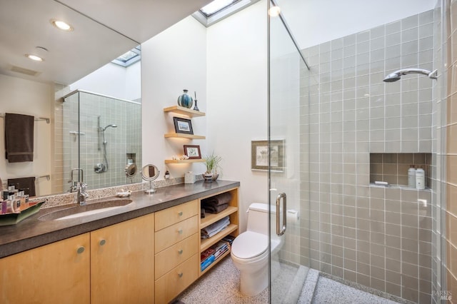 full bath featuring a stall shower, recessed lighting, toilet, vanity, and speckled floor