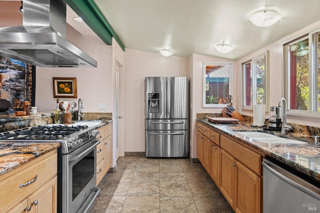 kitchen featuring extractor fan, stainless steel appliances, dark stone countertops, sink, and light tile patterned flooring