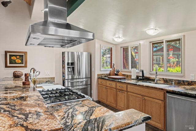 201 Pine Ridge Rd, Ukiah, CA 95482 - kitchen featuring appliances with stainless steel finishes, a sink, ventilation hood, brown cabinetry, and dark stone counters