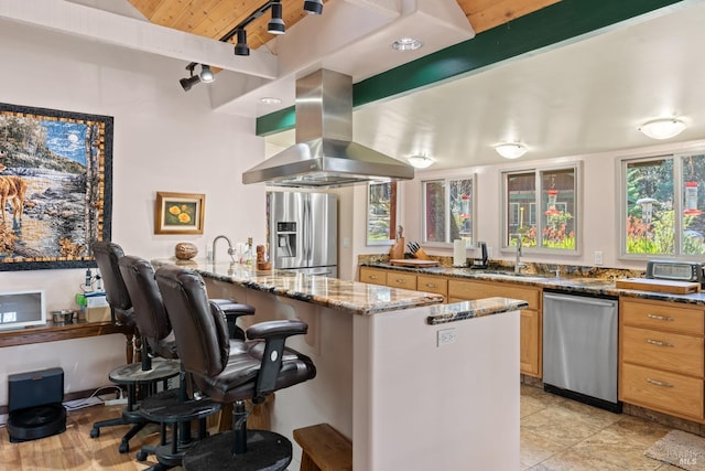 201 Pine Ridge Rd, Ukiah, CA 95482 - kitchen with island exhaust hood, a sink, a peninsula, dark stone countertops, and stainless steel appliances