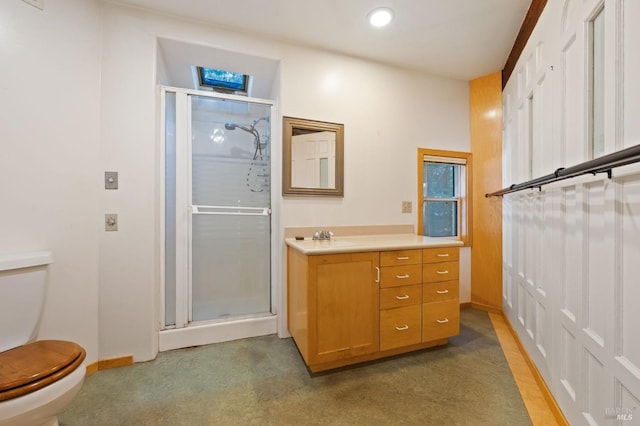 bathroom with vanity, toilet, and walk in shower