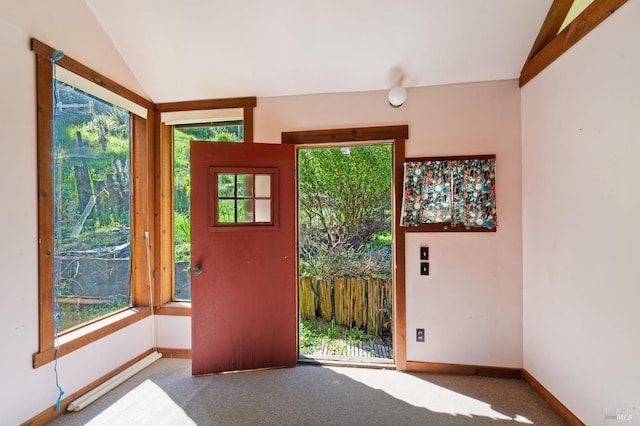 entryway with carpet and lofted ceiling