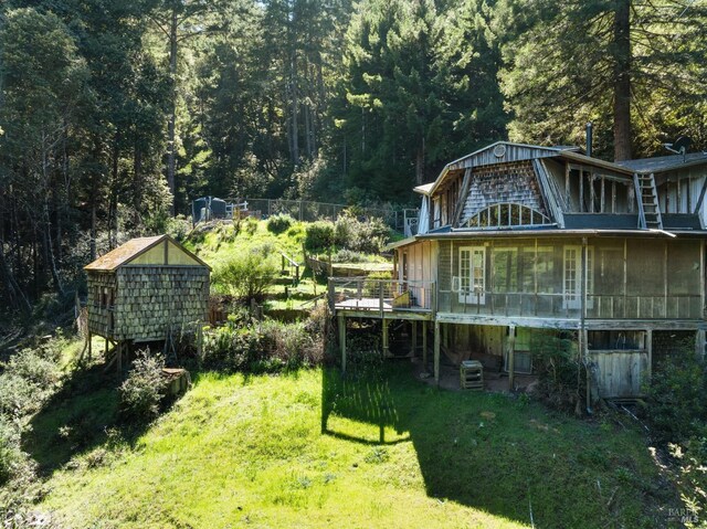 view of yard featuring a shed and a wooden deck