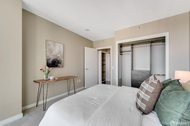 bedroom featuring light colored carpet and a closet