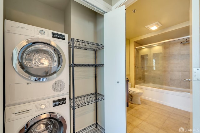 laundry room featuring stacked washer / drying machine