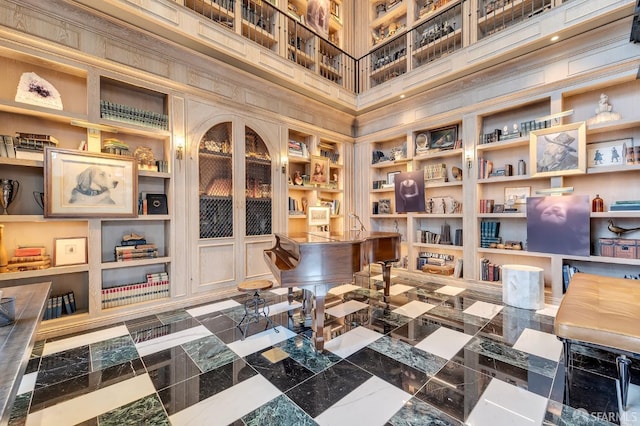 office space with a high ceiling and wooden walls