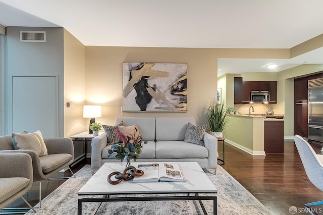 living room featuring dark wood-type flooring and sink