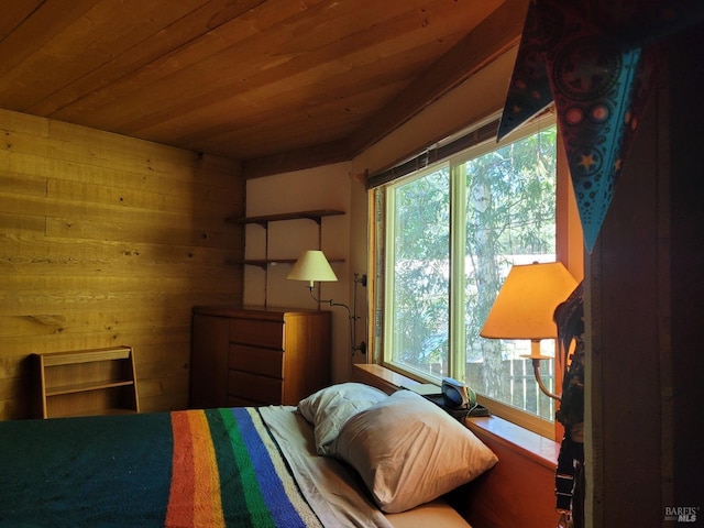 bedroom featuring wooden walls and wooden ceiling