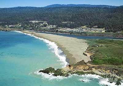 drone / aerial view with a water view and a view of the beach